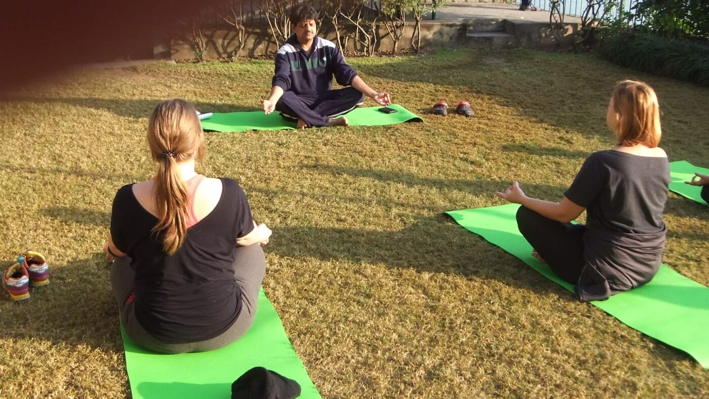 Two guests meditating outdoors