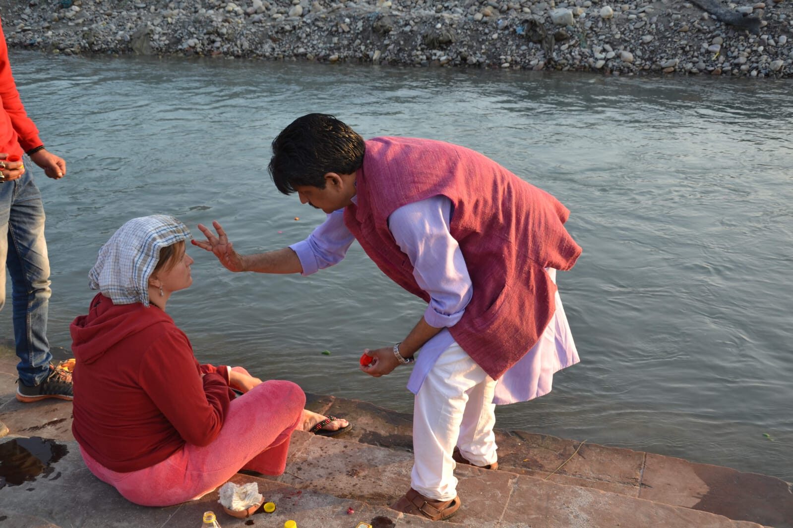 Acharye Rajeev performing a blessing beside the Ganga for a retreat guest